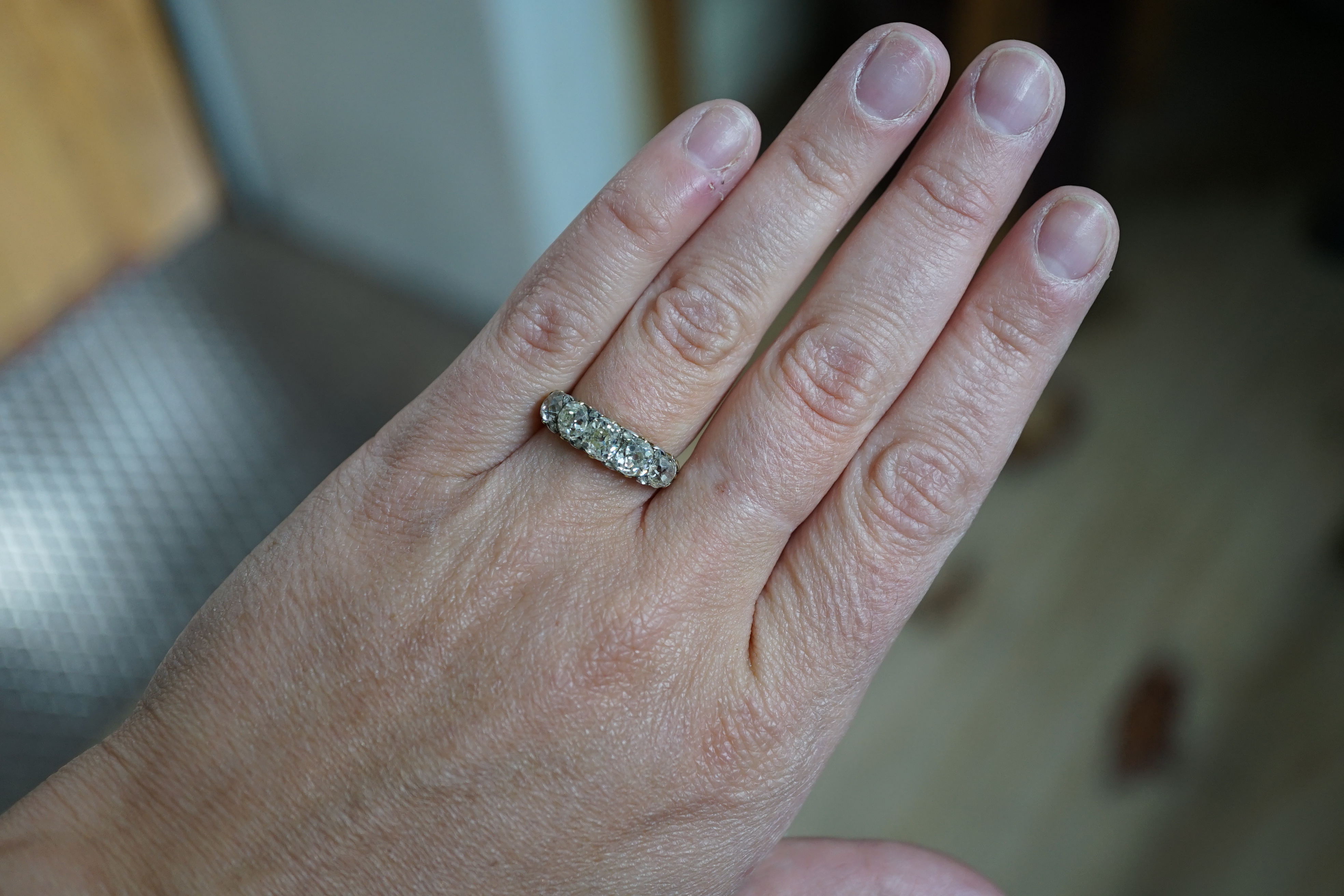 A Victorian 18ct and graduated five stone old round cut diamond set half hoop ring